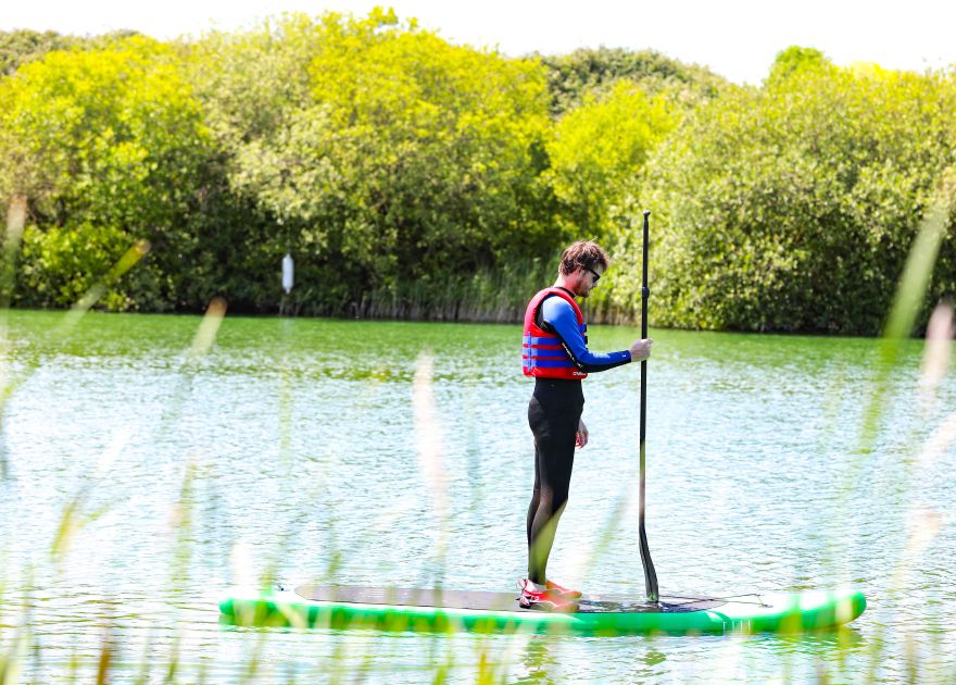 SUP for non-swimmers paddleboarder standing with life vest