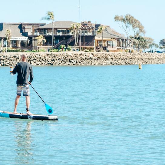 Man on SUP paddleboard in a marina