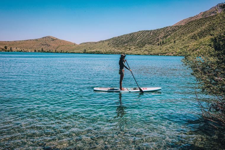 Person standing on a SUP on a lake